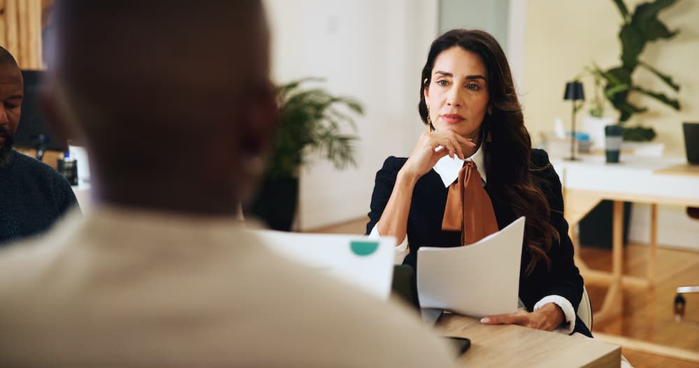 Lawyer discussing sensitive legal matters related to family law and domestic violence with a client in an office setting.